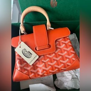 This is a Authentic GOYARD Saïgon Souple Mini Bag in ORANGE hard to get.